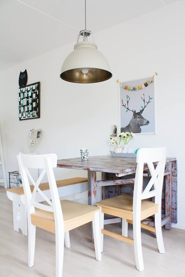 stained dutch-style dining table against the wall