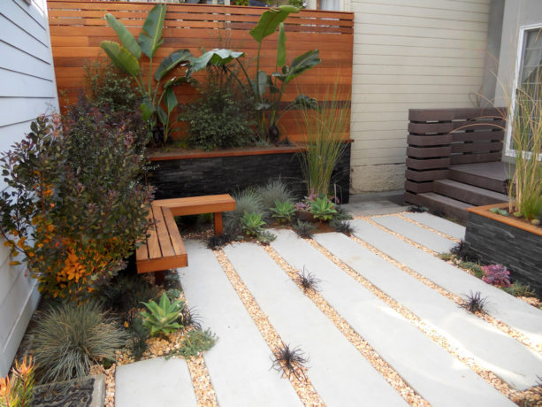 tan colored pea gravel walkway with long concrete slab stepping stones