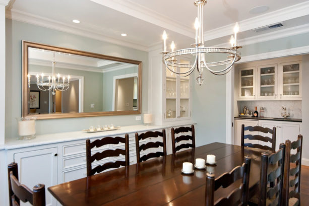 traditional dining room with built-in hutch and painted inset cabinet wet bar