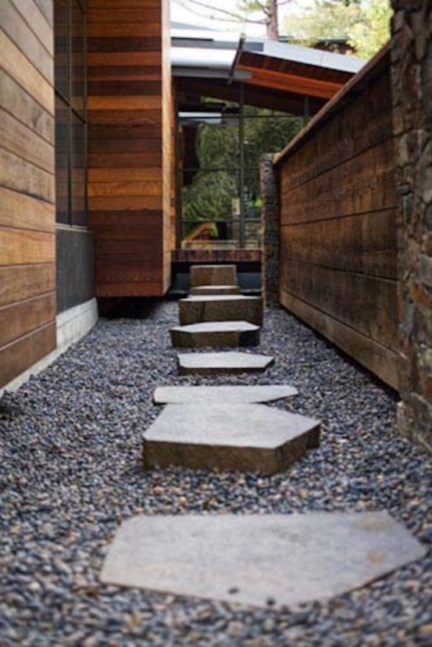 trendy landscaping with pea gravel walkway and stepping stones in different heights