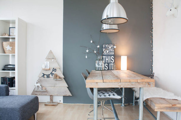 wood top and metal structure dining table against the dark gray wall