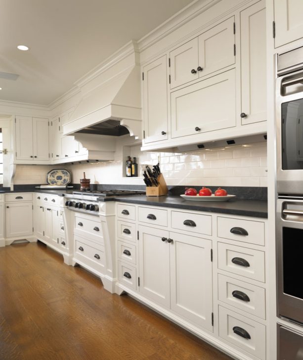 classic kitchen with white cabinets and black unlacquered hardware