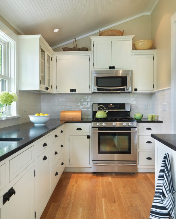cottage style kitchen with white cabinets and black oiled bronze hardware