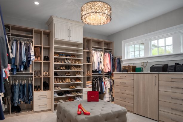 elegant mounted chrome lighting over an ottoman in a walk-in closet