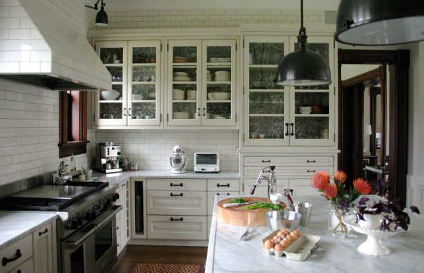 glazed ivory white cabinets with black hardware in a transitional kitchen