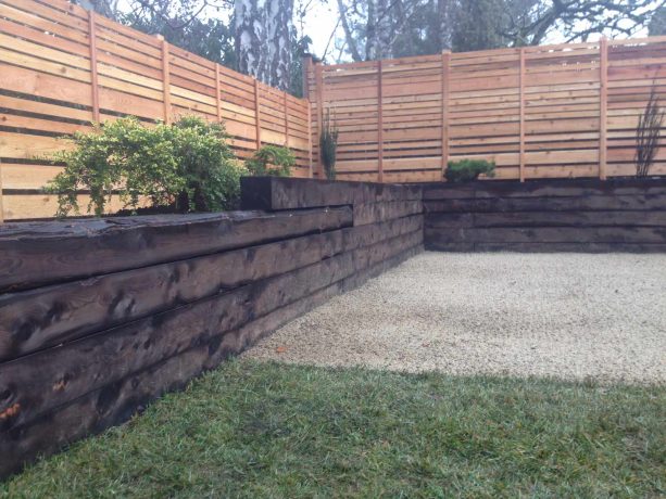 juniper wood retaining wall idea in a mid-century backyard