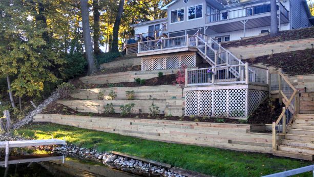 light tone wood retaining wall completed with stairs and decks