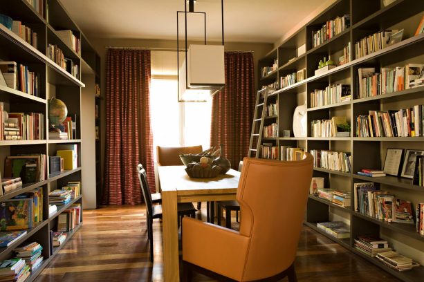 long table in a contemporary dining room library doubles as a desk