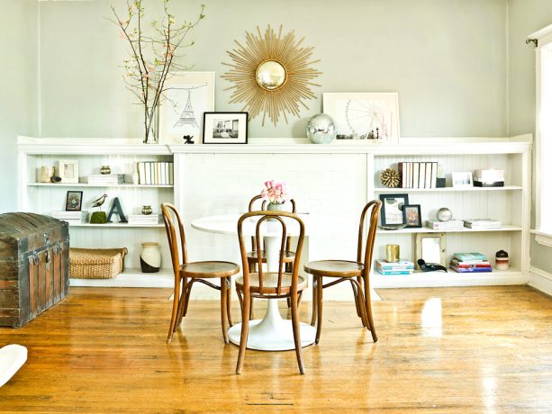 round dining table that is also used as a desk in an eclectic dining room and home office