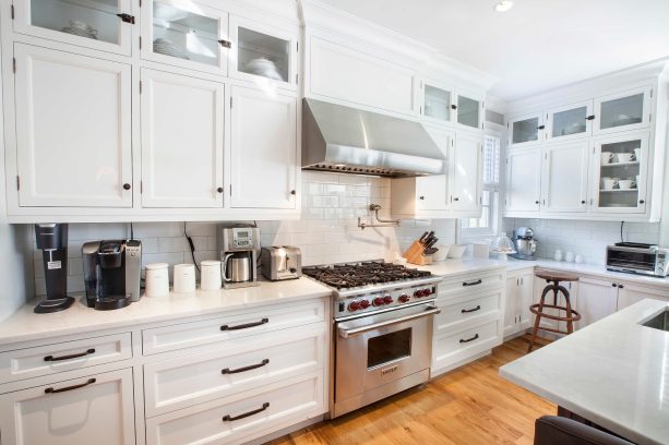 transitional kitchen with crisp white kitchen and black brushed satin nickel hardware