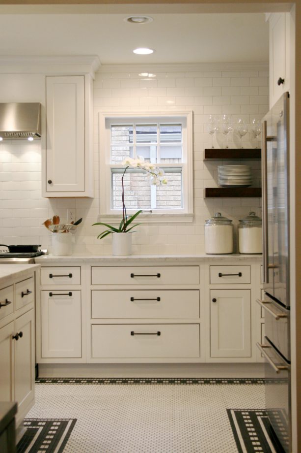 white flat-panel cabinets with black pulls and knobs from restoration hardware