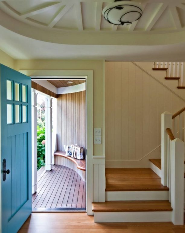 combination of the teal front door and soft yellow walls