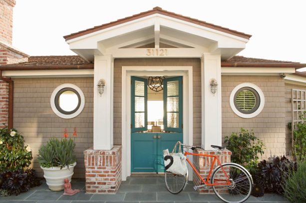 teal double dutch front doors in a beach style exterior