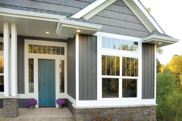 transitional style exterior with a single front door in teal