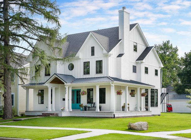 white farmhouse exterior with teal double front doors