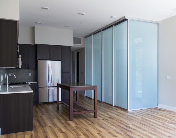 aluminum framed opaque white glass as a corner room divider in a studio apartment