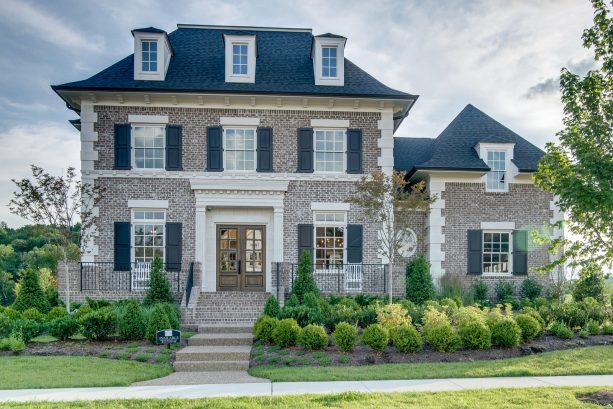 black hip roof and gray brick exterior color scheme for a timeless look