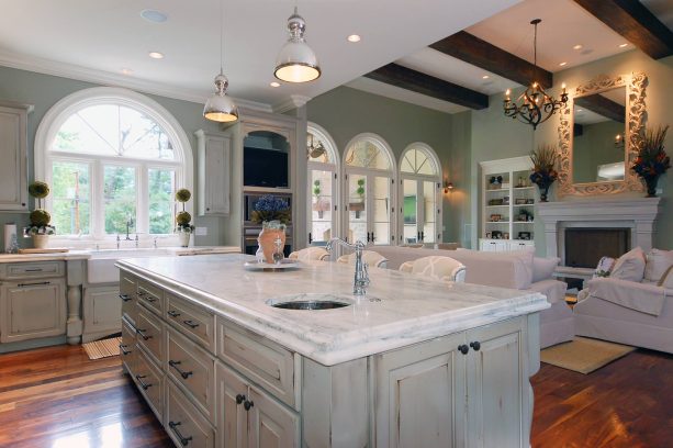 combination of polished marble slab countertops and distressed white cabinets