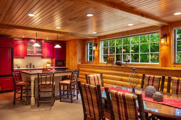 contemporary log cabin kitchen with red cabinetry to spice up the wooden area