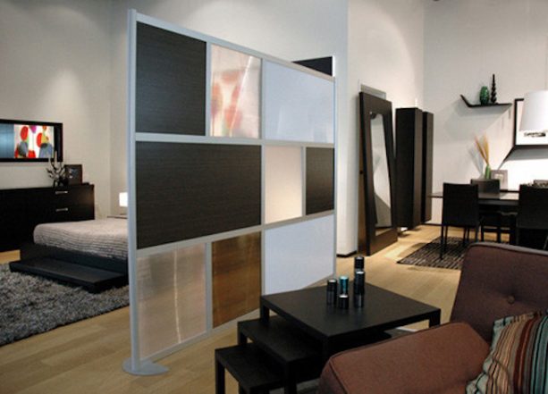 contemporary studio apartment room divider with a combination of ebony wood laminate, white, and translucent panels