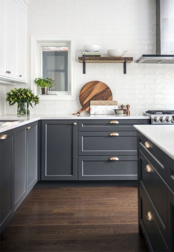 dark gray recessed panel cabinets paired with white marble countertops in a contemporary kitchen