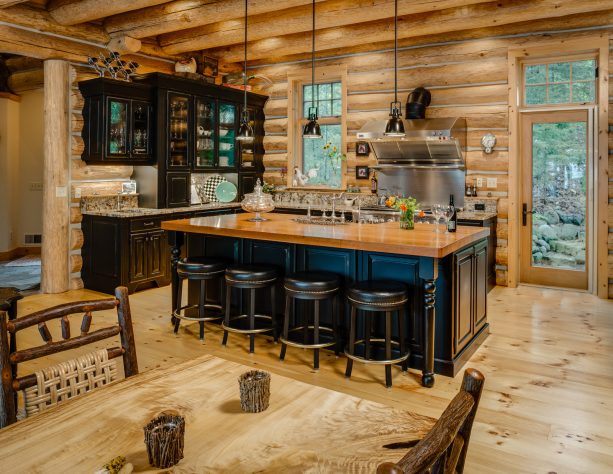 deep blue island as a splash of color in a brown log cabin kitchen