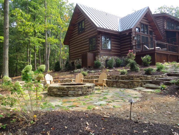 huge rustic backyard with mulch landscaping and a fire pit for summer