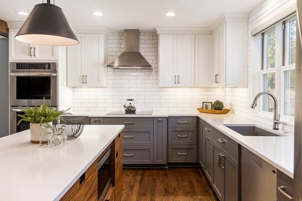 l-shaped kitchen with two-tone gray and white cabinets and white quartzite countertops