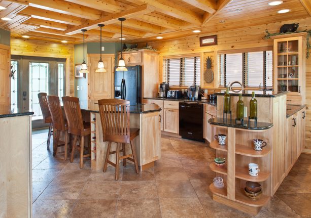 large log cabin kitchen with porcelain tile floor and black appliances as an accent