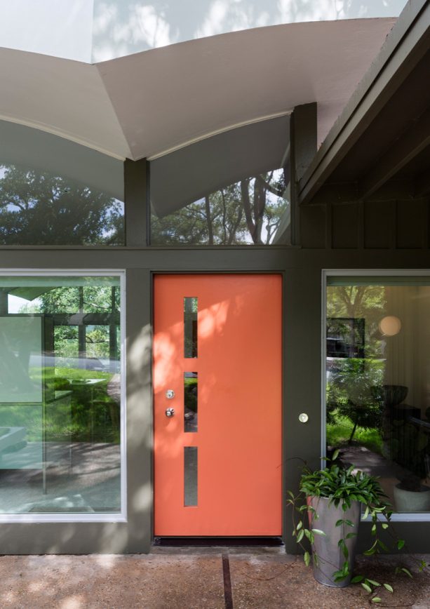 mid-century entry with coral front door and dark gray walls