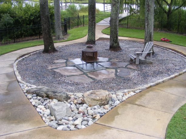 mid-sized rustic gravel landscaping with a fire pit for fall
