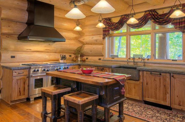 polished log walls in a cabin kitchen to create a sleek rustic look