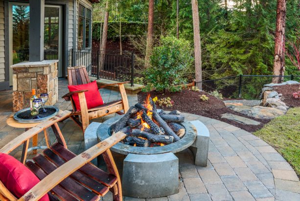 rustic patio with gas fire pit from quadra-fire surrounded by adirondacks chairs