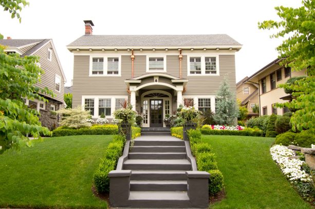 traditional style front stairs and landings are made of dark colored concrete
