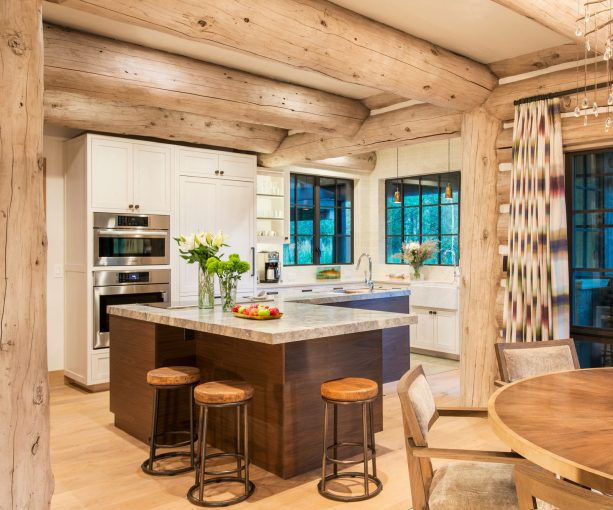 trendy log cabin kitchen with light tone wood and white element accentuated by dark island