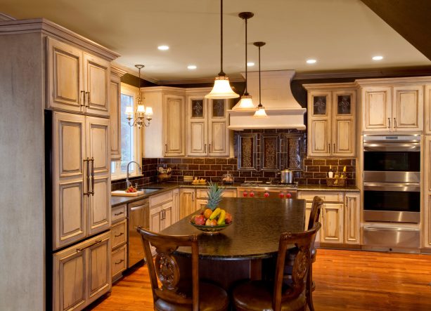 welcoming kitchen with distressed white cabinets and cherry island to create a warm tone