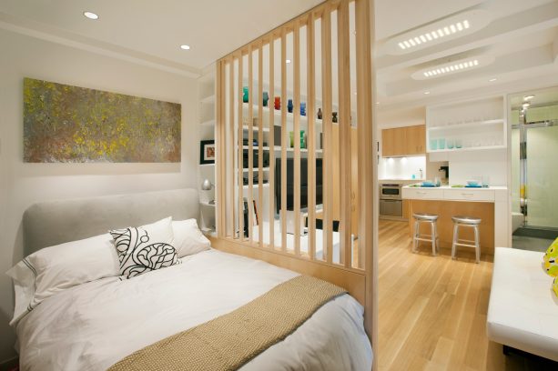 wooden panels as a room divider to make the bedroom in a studio apartment more private