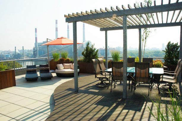 an elevated area is higher than the concrete surface as a floating deck with a pergola on the rooftop