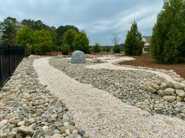 backyard rock garden to address drainage issues around the property