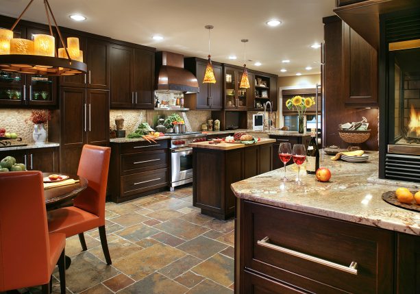 cherry wood with walnut stain cabinets and light typhoon bordeaux granite countertops in a slate floor kitchen