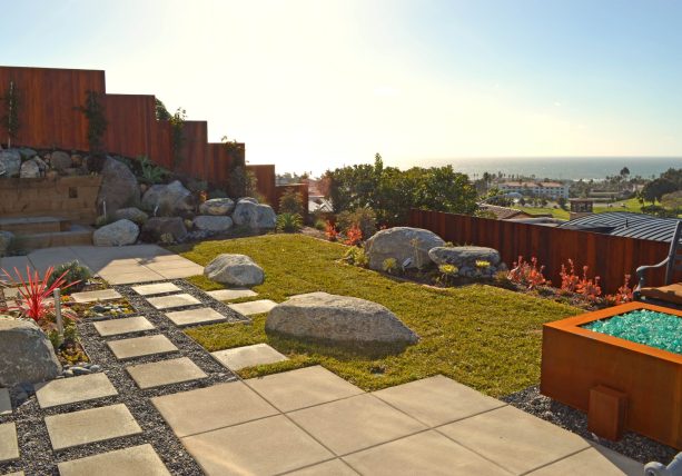combination of poured concrete and rock landscaping with boulders in a contemporary style