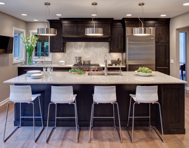 dark chocolate cabinetry and light cashmere white countertops that match the backsplash