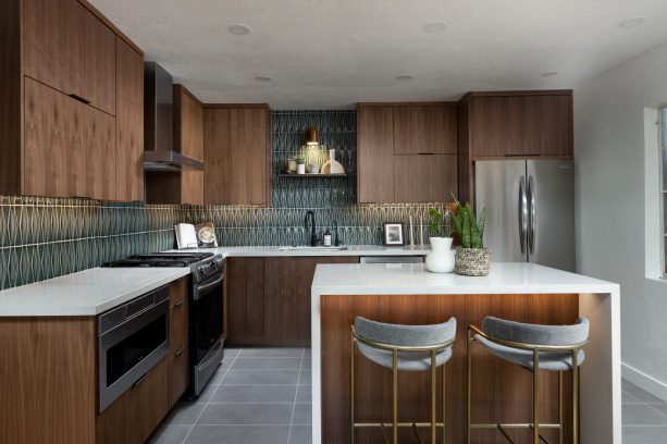 gray kitchen floor paired with dark tone walnut cabinetry and emerald green backsplash