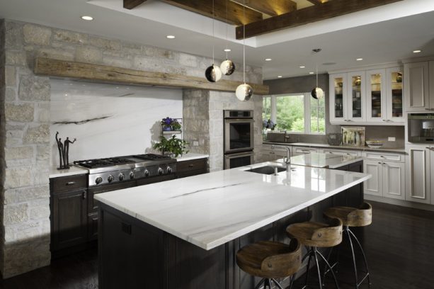 merging old look and contemporary design by pairing dark cabinets with light countertops, backsplash, and reclaimed wood elements