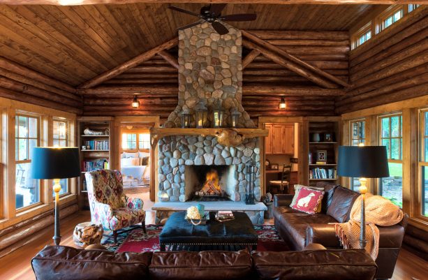 mid-sized rustic living room with brown color and black accent complemented by stone element