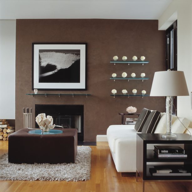 pleasant living room with brown venetian stucco wall and black fireplace