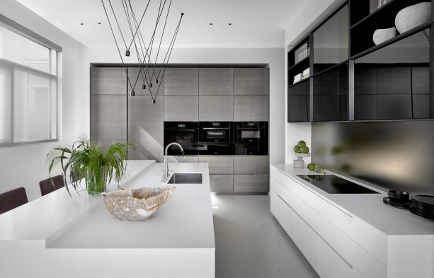 polished gray floor combined with gray cabinets and metallic backsplash