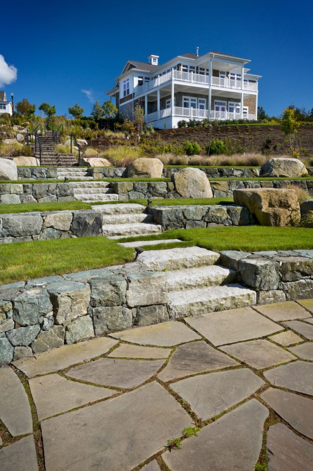 stone landscaping with decorative boulders and shaped rocks as a terraced retaining wall