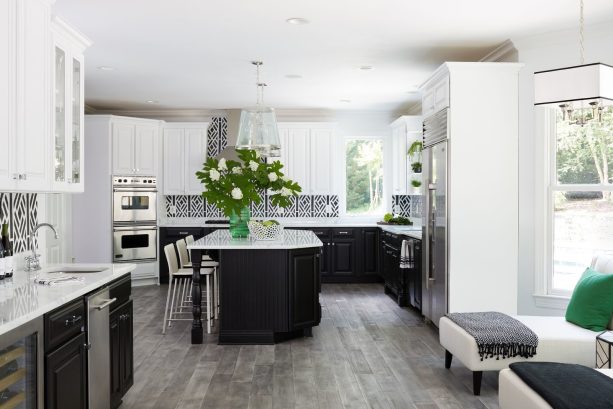 the gray kitchen floor is made of wood combined with black and white cabinets