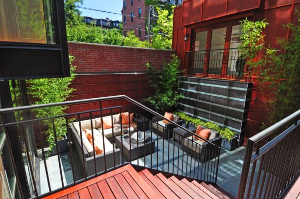 an enclosed townhouse patio with comfortable seating fills most of the space